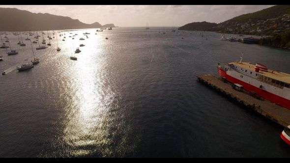 Sailboats with Sun and Ship Bequia Royalty Free Stock Drone Video Footage