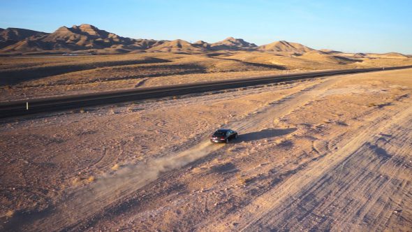 Black Car On a Desert Highway Royalty Free Stock Drone Video Footage