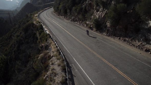 Mountainside Cyclist 3 Royalty Free Stock Drone Video Footage