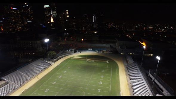 Wide aerial, football field at night in city Royalty Free Stock Drone Video Footage